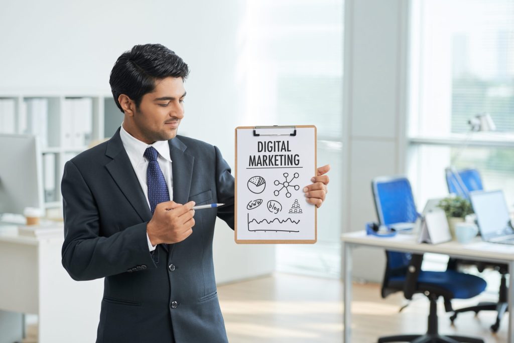 man-suit-standing-office-with-clipboard-pointing-poster